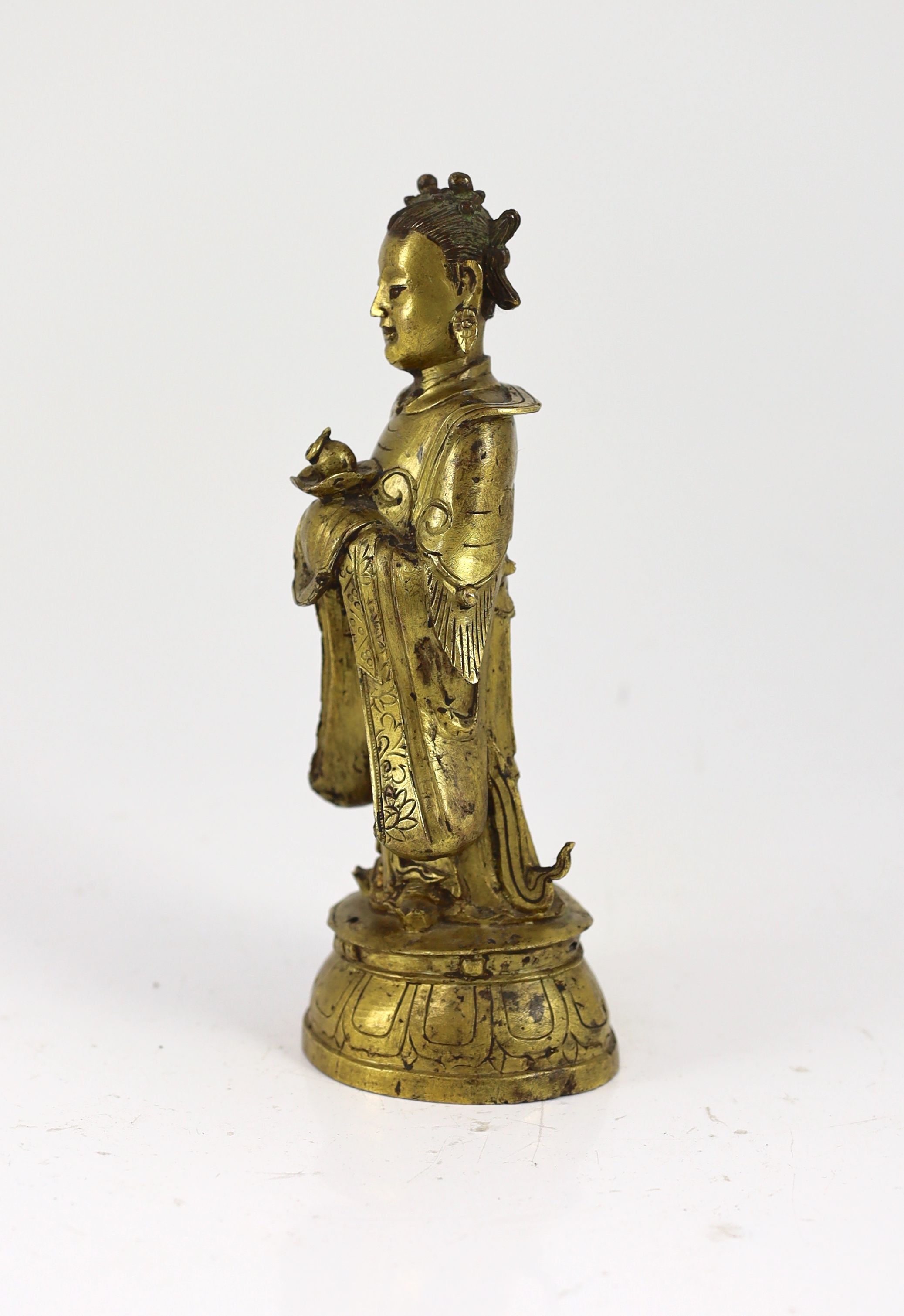 A Chinese Ming gilt bronze figure of an immortal, 16th/17th century, 24.5cm high